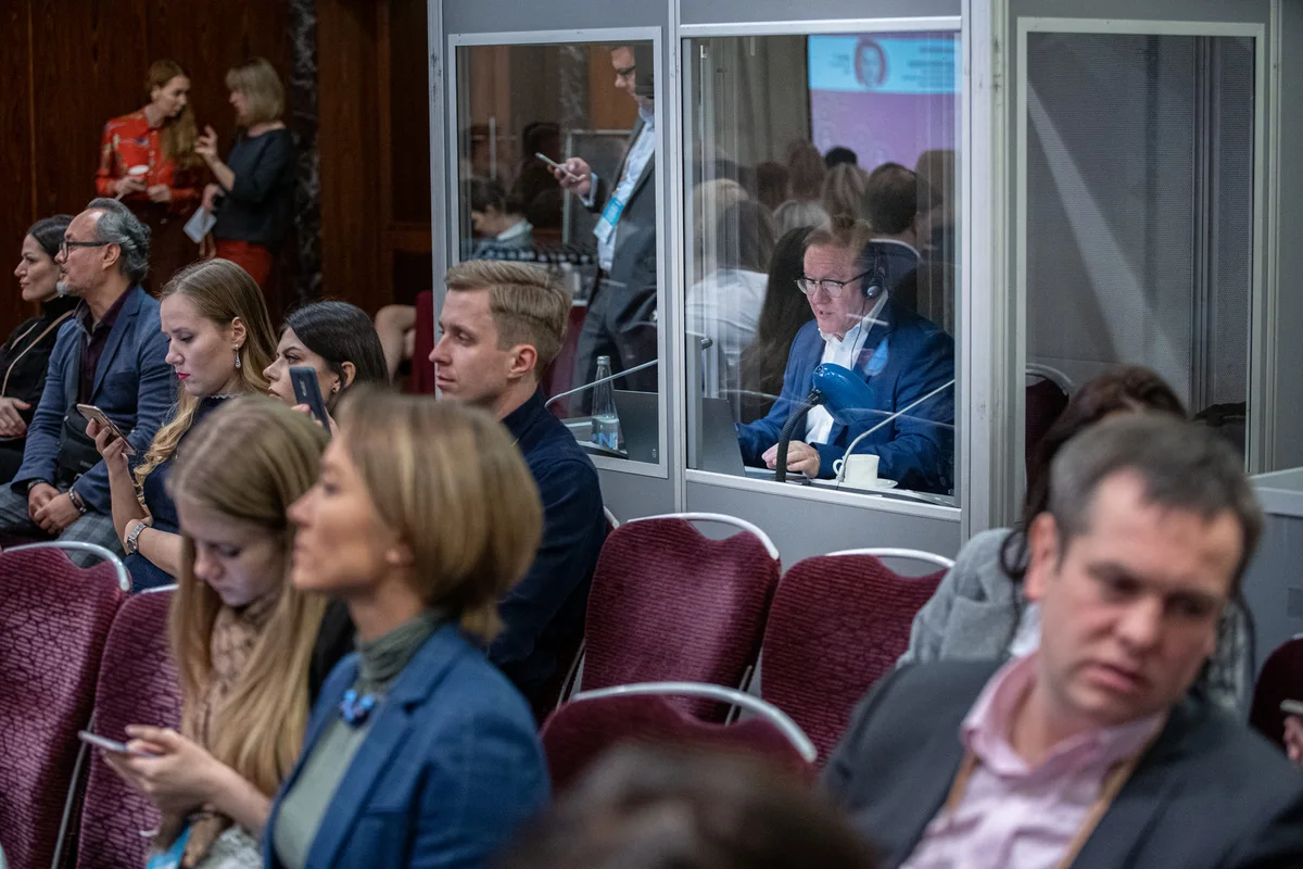 Viktor Kozyrev interpreting from a booth during a live conference
